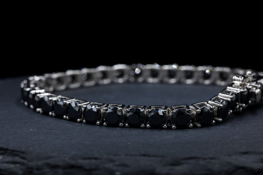 Silver bracelet with black moissanite gemstones stones on a dark surface